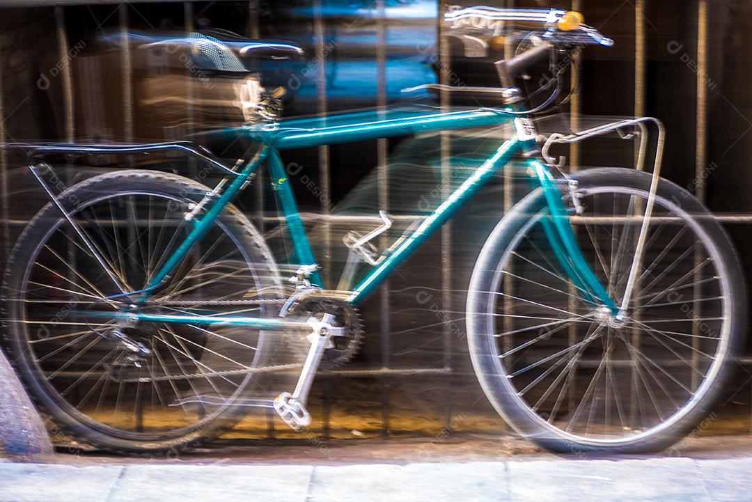 Uma bicicleta turva em frente a um portão.