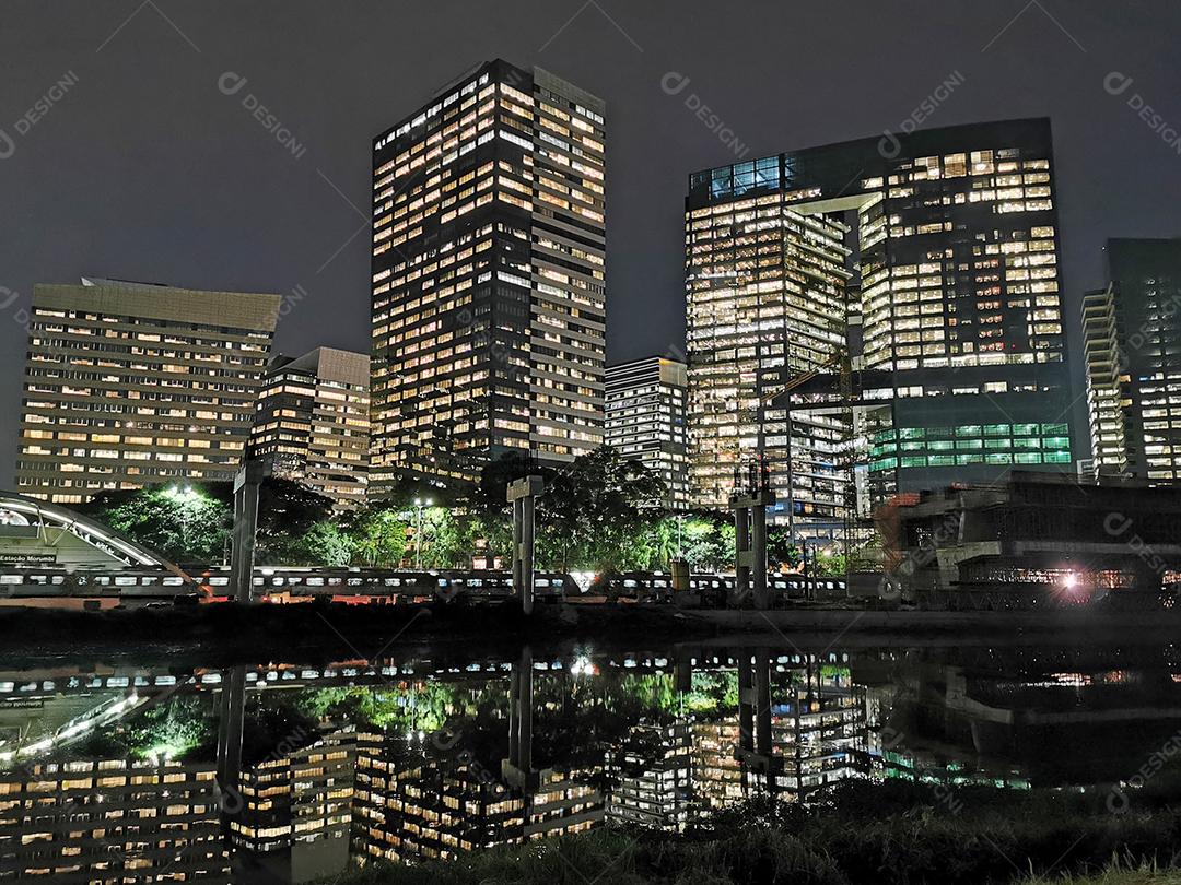 Vista noturna de edifícios na marginal e rio pinheiros.