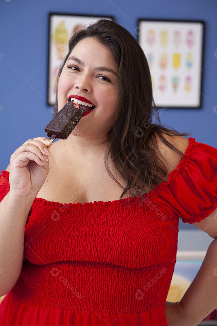 Linda senhora protegida de picolé de morango com cobertura de chocolate.