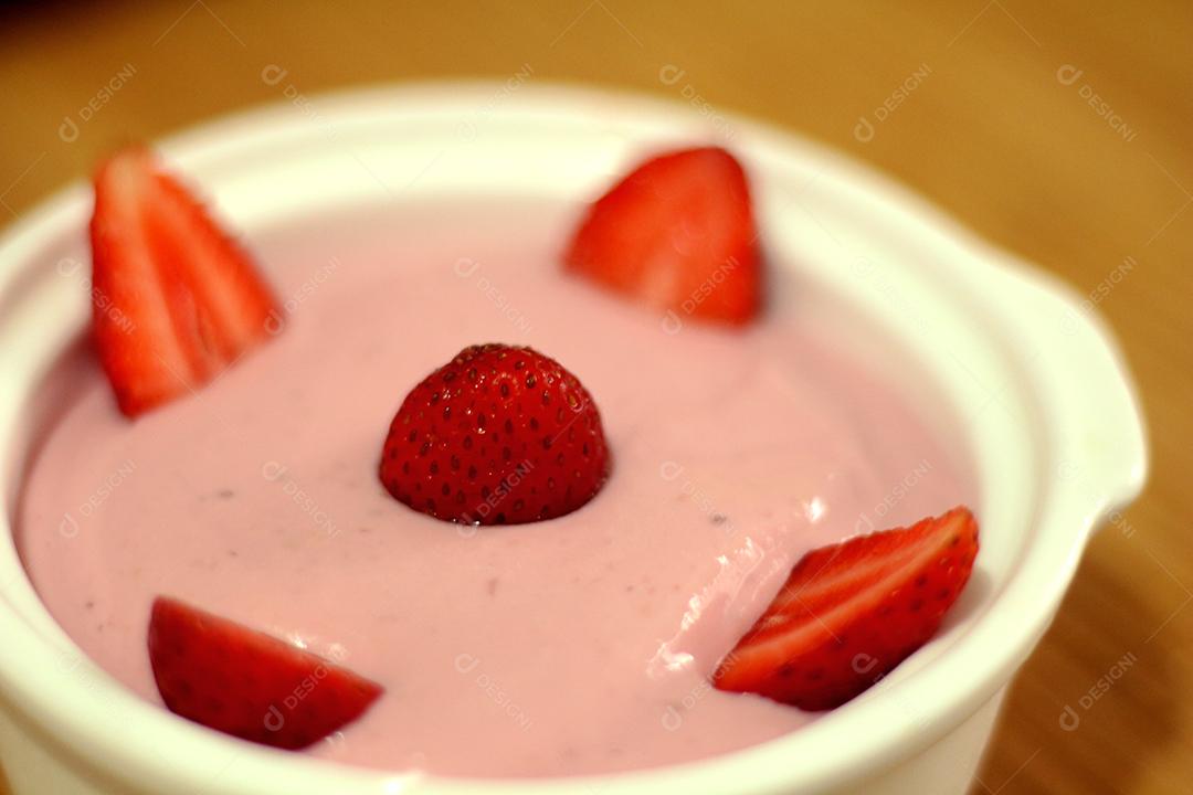 Comida Iogurte caseiro sobre tigela com morango por cima