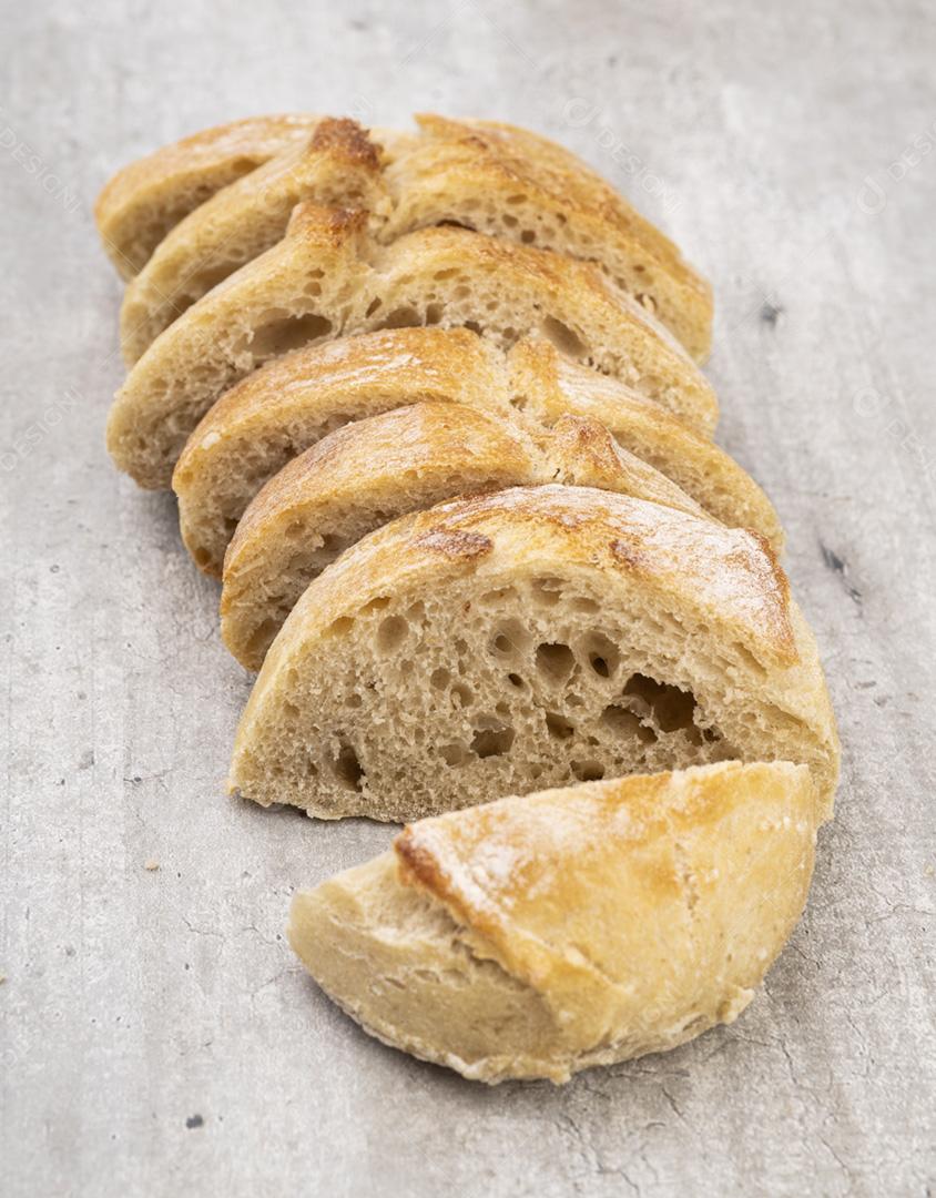 Slices of traditional homemade French baguette bread on a wooden board