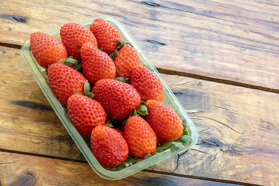 Bandeija de morango frutas comida sobre uma mesa de madeira