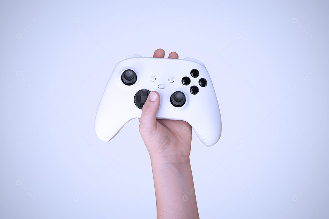 Boy holding game controller on white background