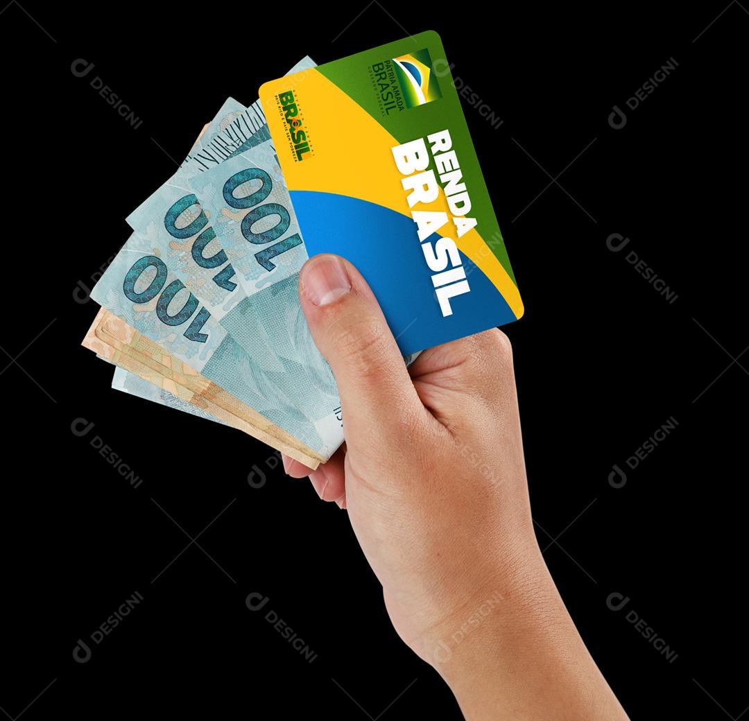 Curitiba, Paraná, Brasil, 06 de setembro de 2020. Mão brasileira segurando cartão e dinheiro do novo programa de ajuda popular chamado Renda Brasil. Novo auxílio emergencial e bolsa família. Fundo da bandeira.