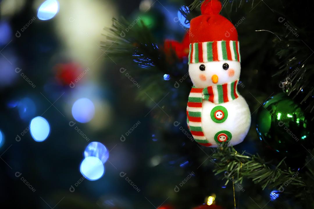 Snowman ornament. Decorated Christmas tree on blurred background