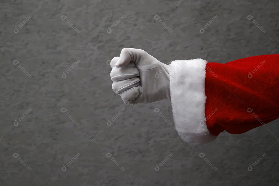 mão fechada com luva de Papai Noel