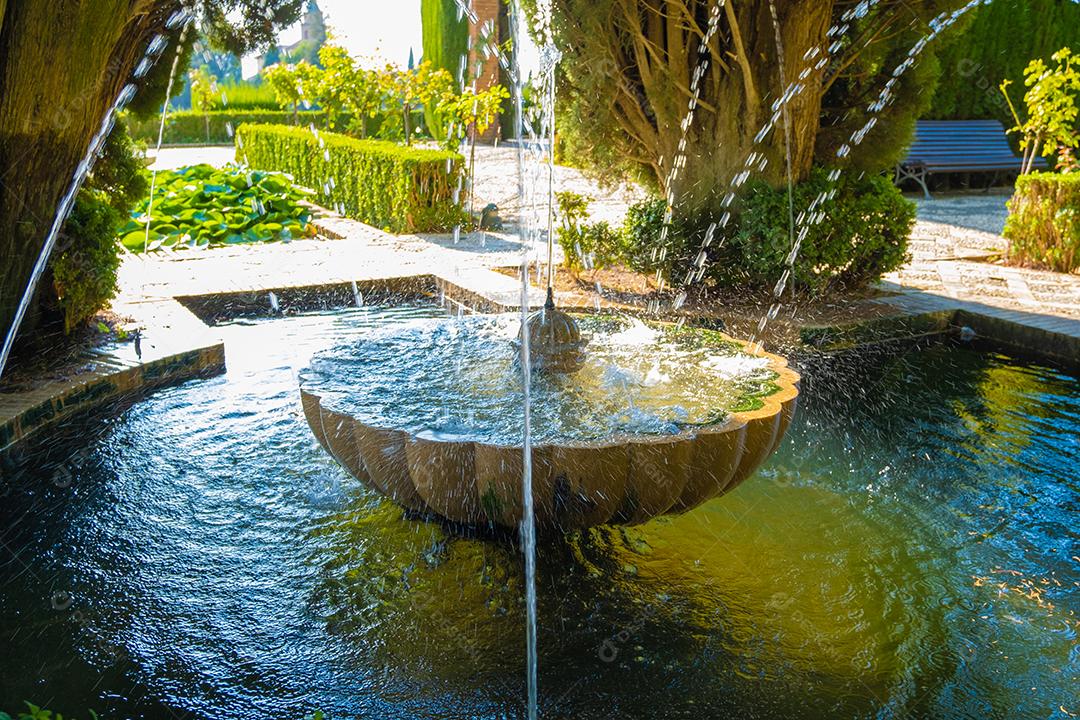 View of the beautiful fountain from the Alhambra gardens in Granada.
