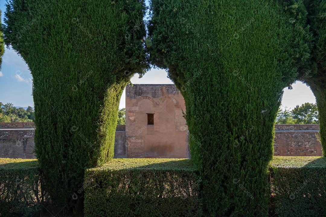 Vista do edifício entre o arco verde das plantas em Alhambra.
