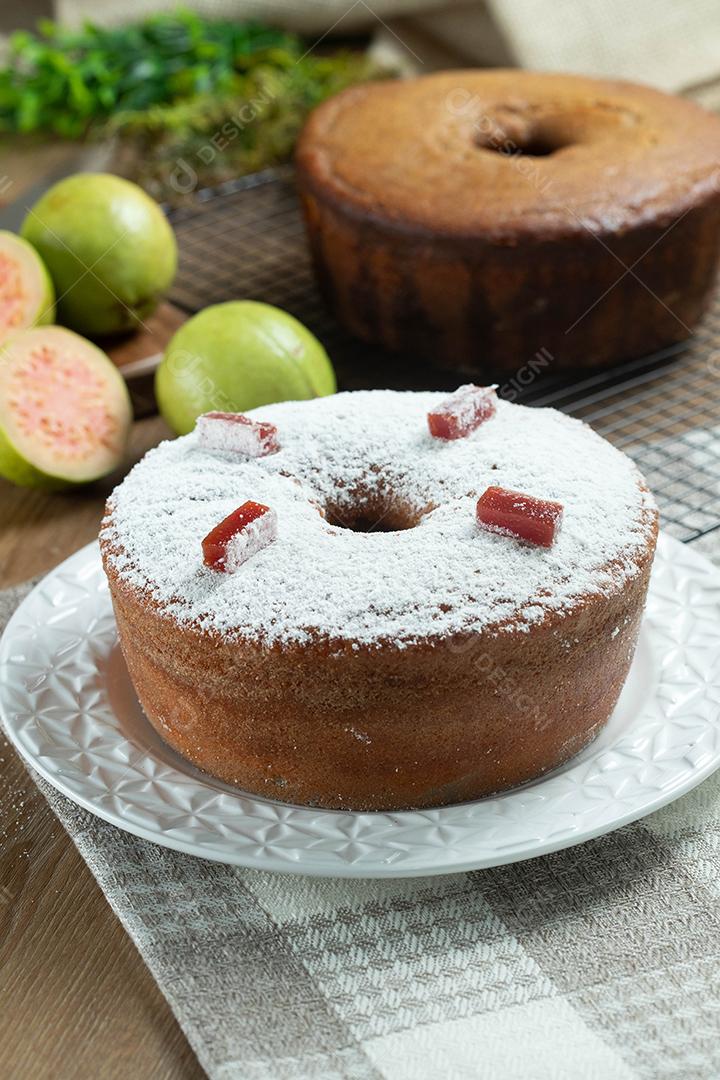 Bolo de milho brasileiro feito com um tipo de farinha de milho (Fuba) recheado com goiabada. Em uma mesa de festa de madeira. Doces típicos da festa junina. bolo de fubá