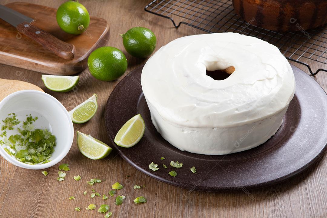 Moist lemon fruitcake on plate with lemon slices on wooden table. Delicious breakfast, traditional tea time. Lemon cake recipe