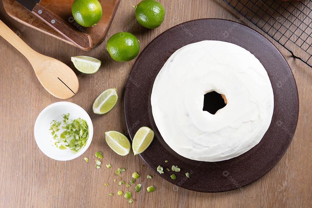 Moist lemon fruitcake on plate with lemon slices on wooden table. Delicious breakfast, traditional tea time. Lemon cake recipe