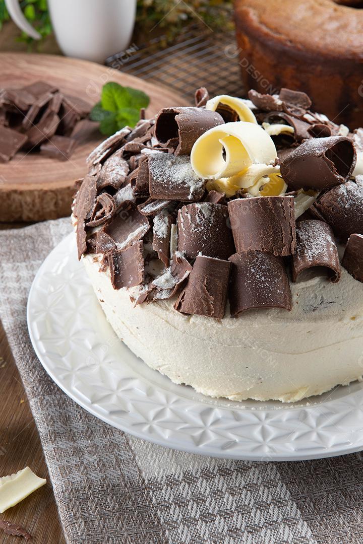 Chocolate branco e bolo de chocolate escuro dois amores na mesa de madeira. Bolo de aniversário e casamento.