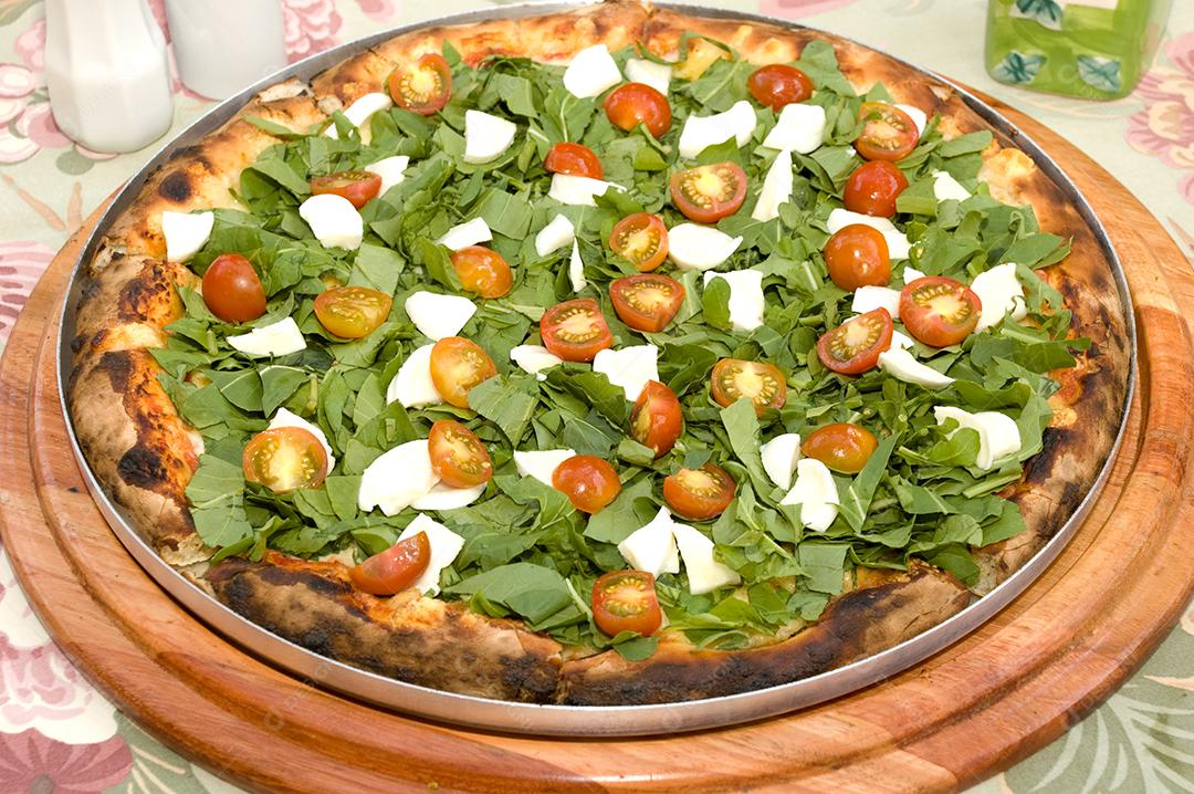 Pizza deliciosa pronta sobre tabua madeira.