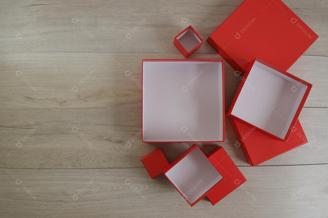 Caixas de presente vermelhas sobre fundo de madeira com espaço