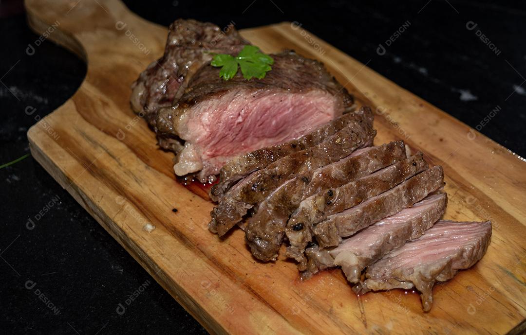 Deliciosa carne assada cortada em tábua de madeira