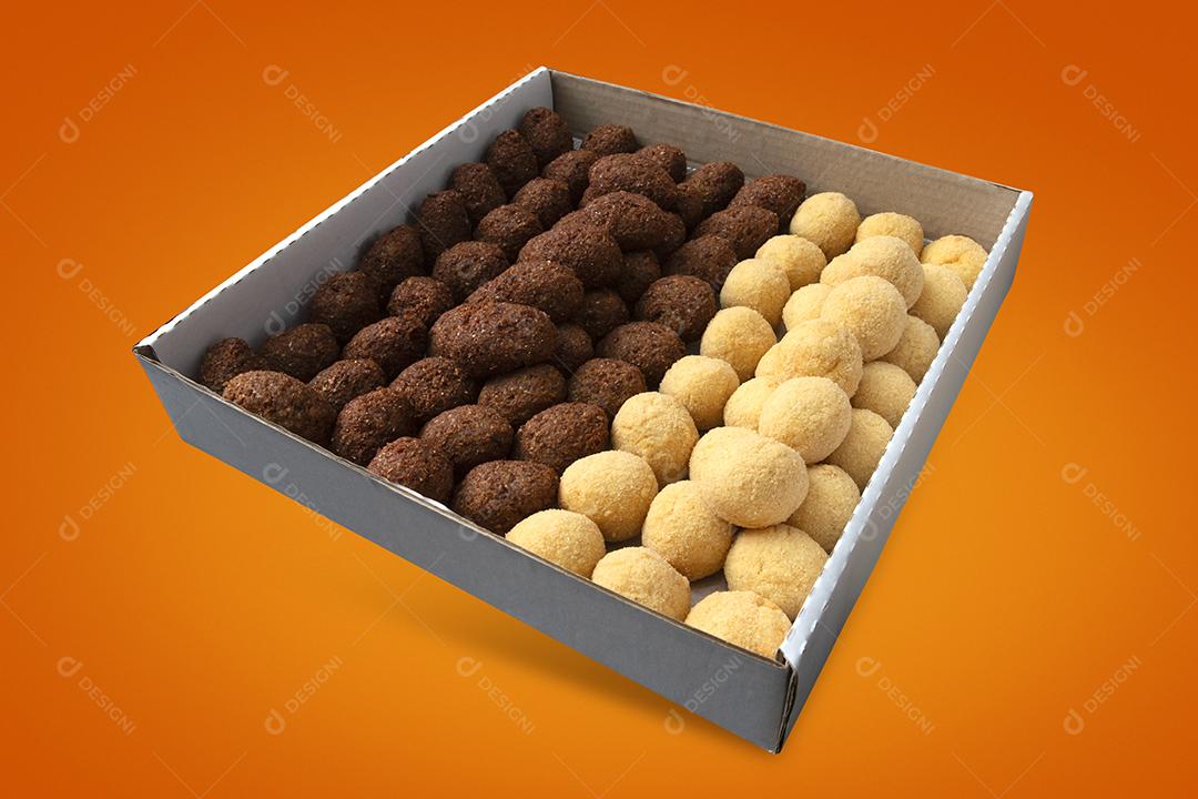 Uma caixa de croquetes fritos e aperitivos para entrega. Coxinha de lanche brasileiro em fundo amarelo e laranja.