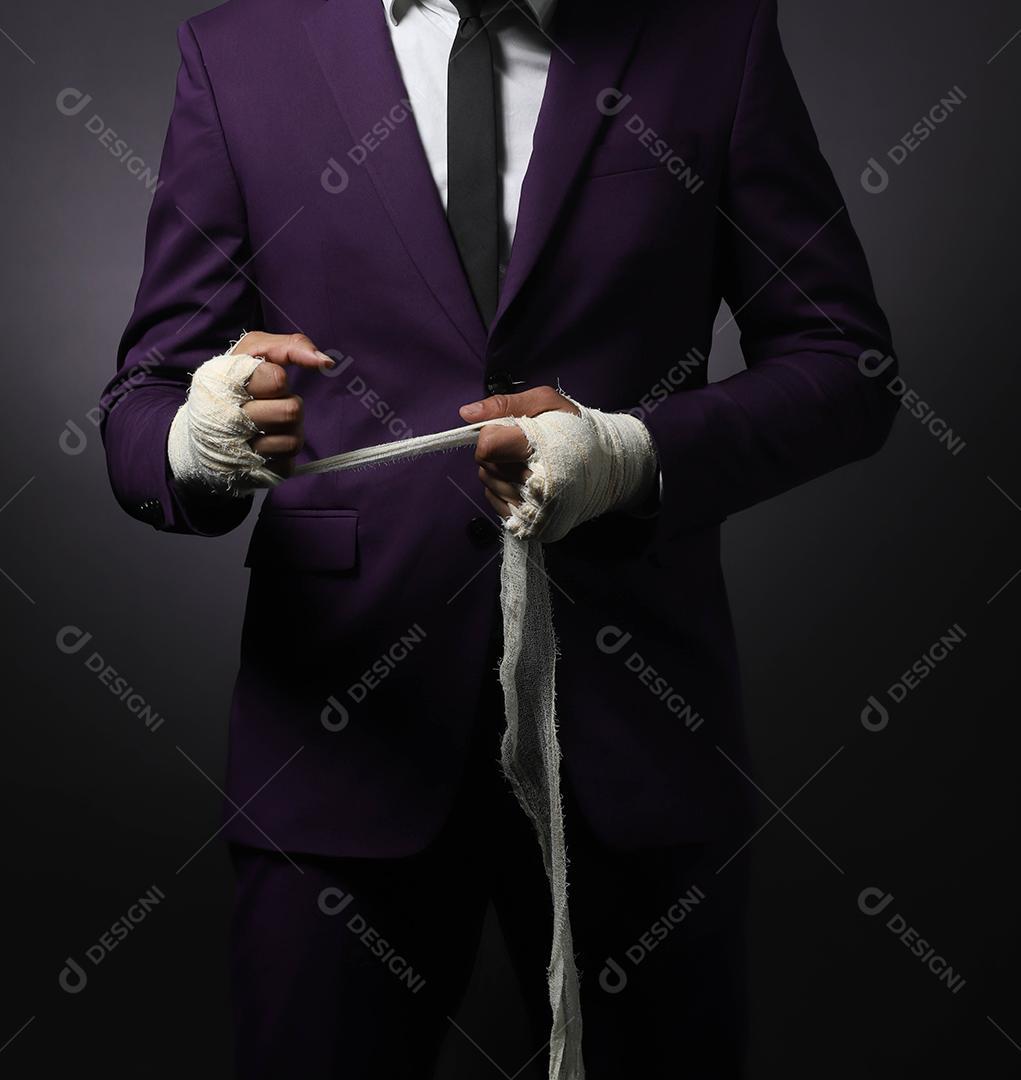 Closed male hand of businessman fighter in suit with bandages and clenched fists