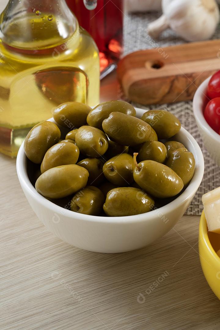 Aperitif jars with cheese, olives and cherry tomatoes.