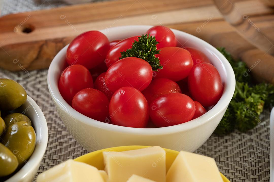 Frascos de aperitivo com queijo, azeitonas e tomate cereja.