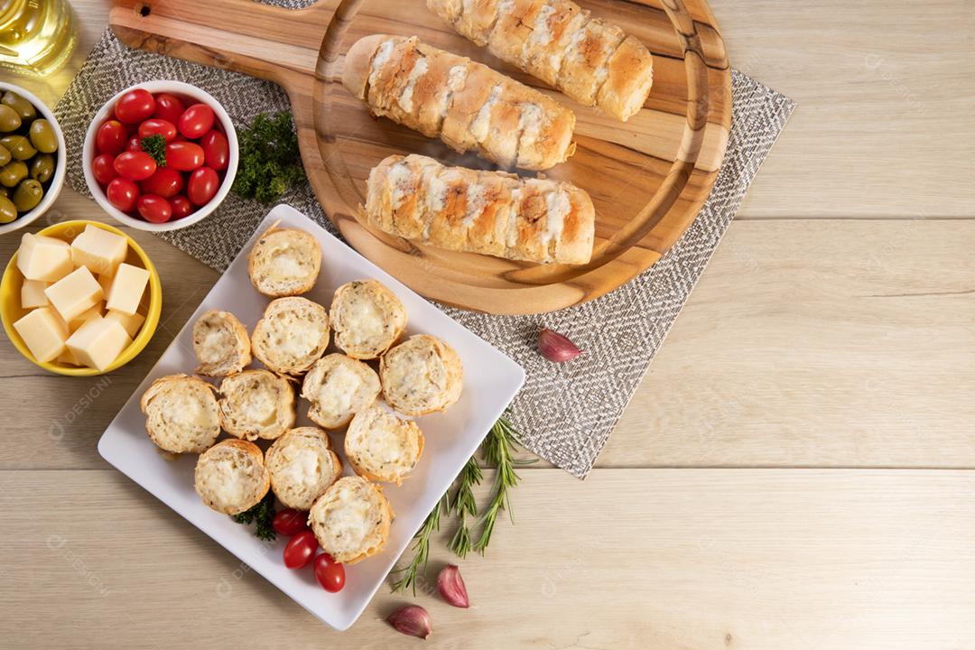 Garlic bread in a white square plate on the table with cheese, ros