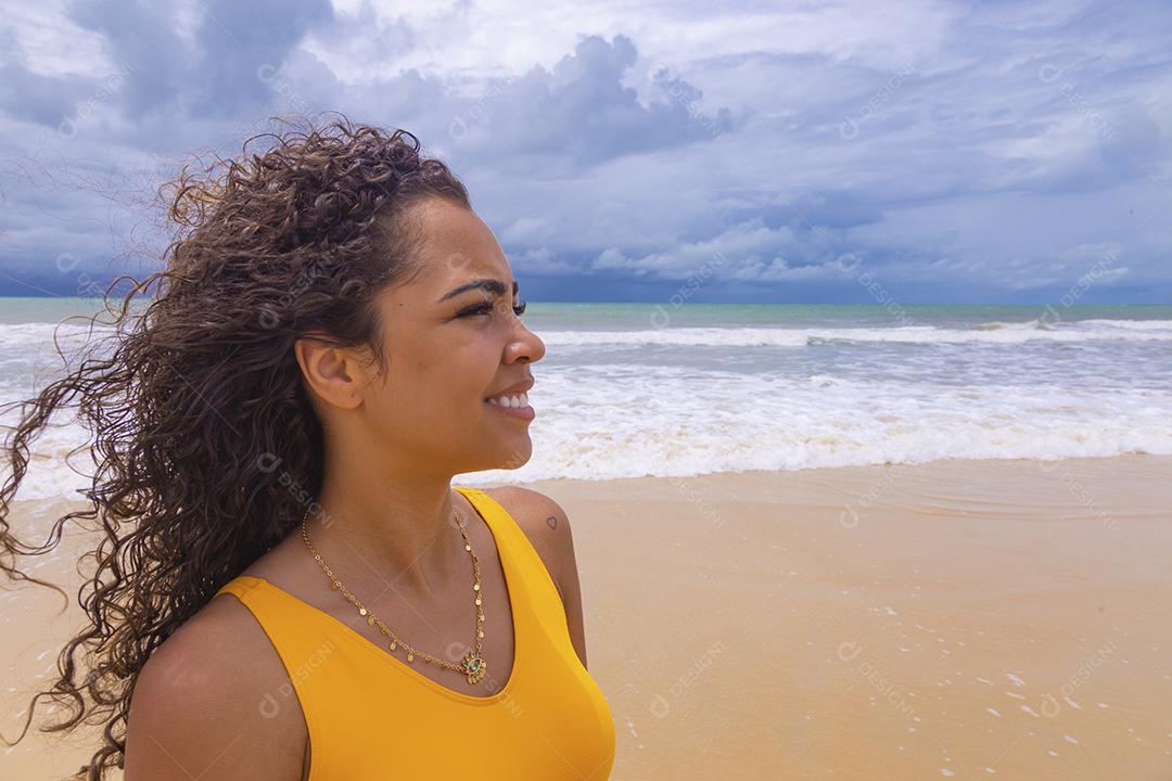 Afro morena jovem bonita, cabelo encaracolado, biquíni, praia. Férias de férias de verão afro-americanas.