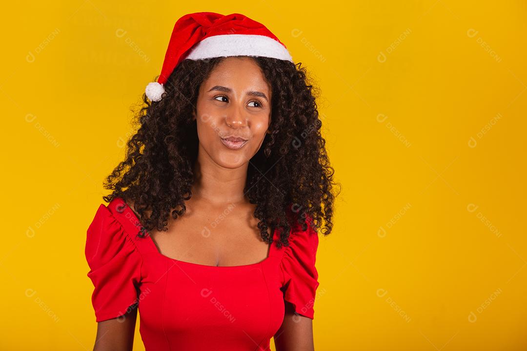 menina bonita e alegre com chapéu de Papai Noel sorrindo para a câmera