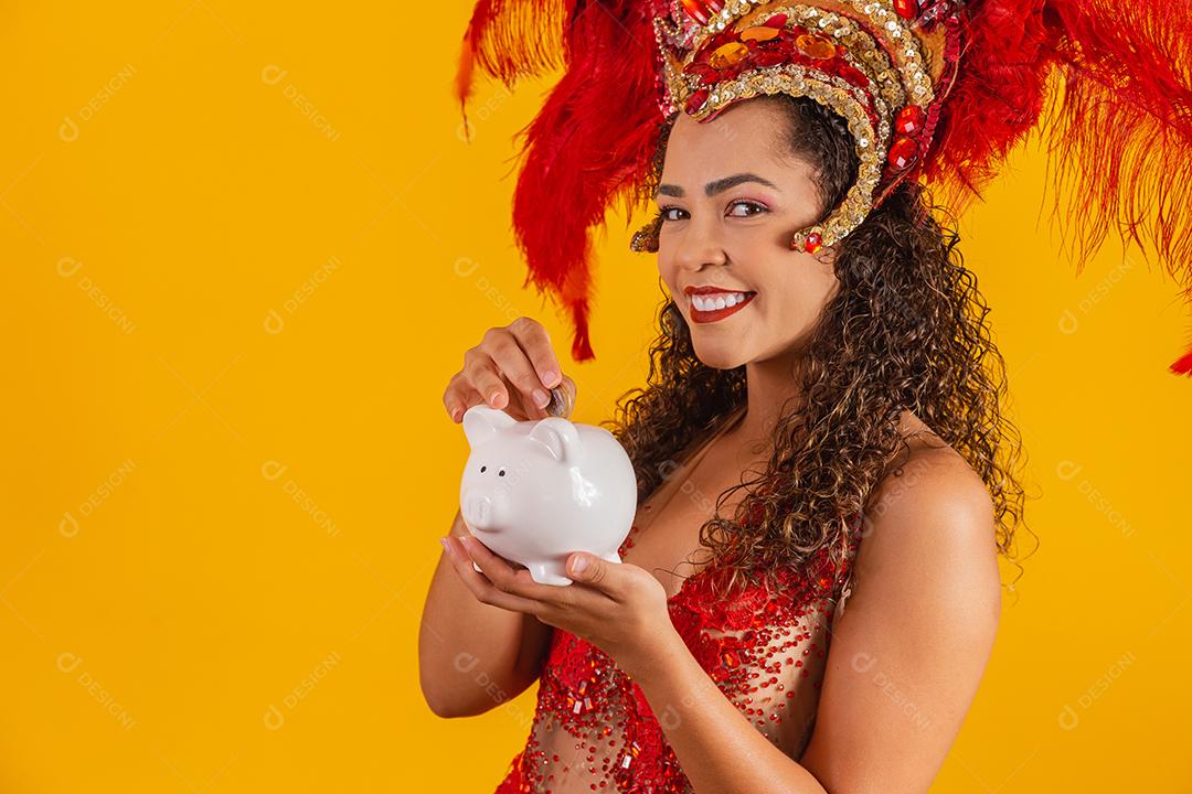 Mulher de dançarina de carnaval segurando um cofrinho nas mãos. Conceito de economia para o carnaval