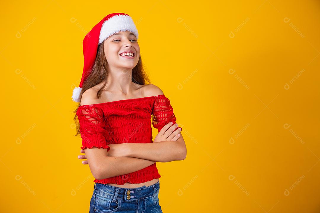 Portrait of a child with hands folded, smiling, ready to help on Christmas Eve