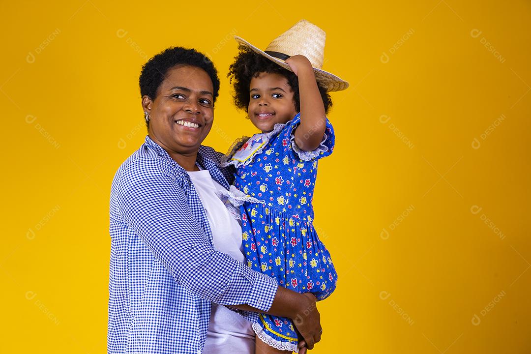 Afro mãe e filha vestidas para festa junina.