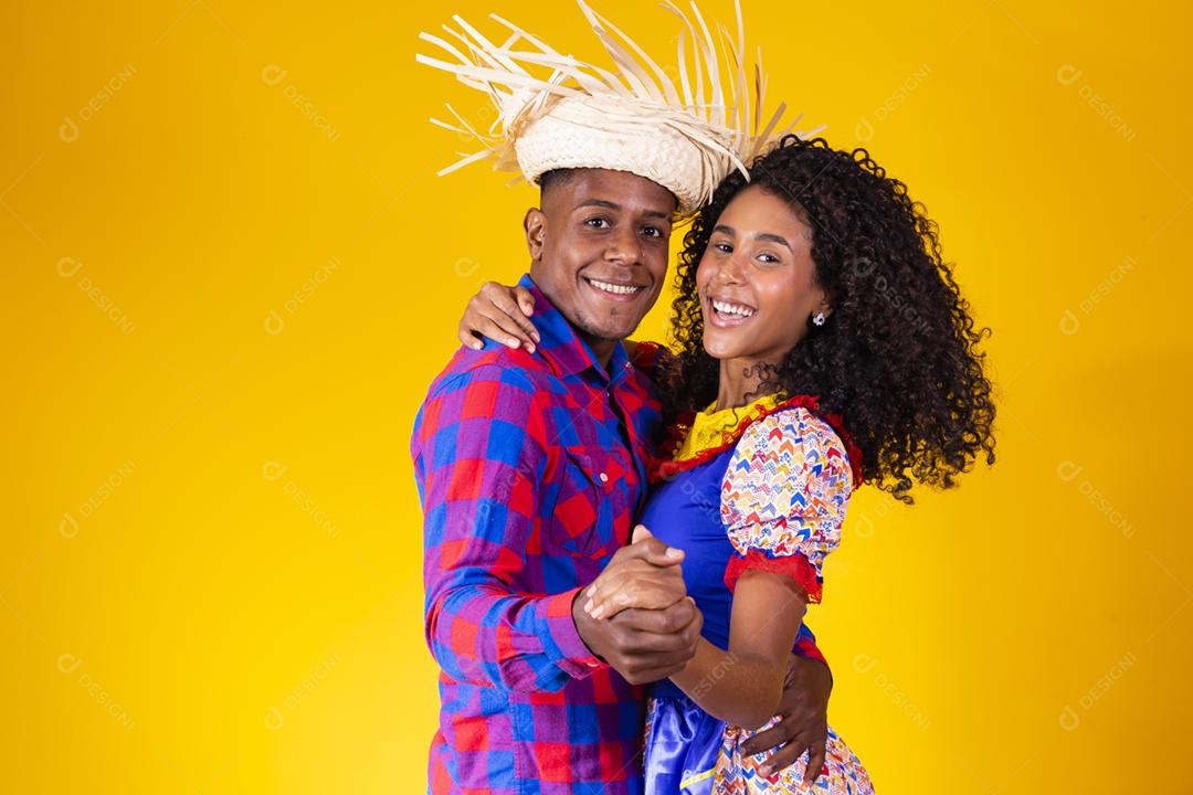 Casal brasileiro vestindo roupas tradicionais para a Festa Junina da