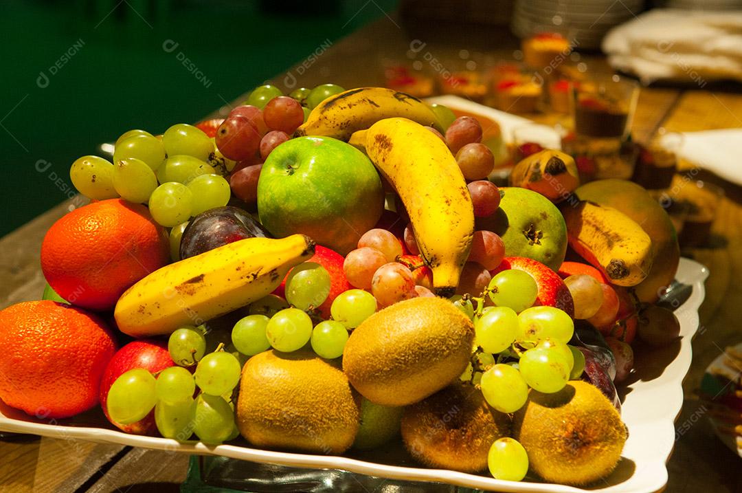 Várias frutas maduras sobre mesa madeira