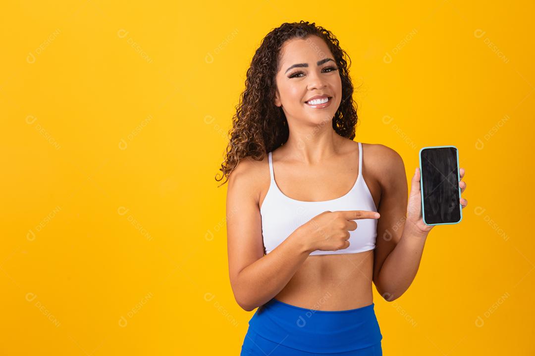 Aplicativo de esportes. Retrato de jovem animado em forma segurando e mostrando