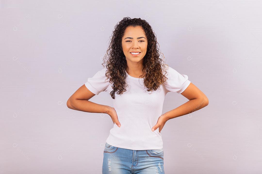 Mulher afro com cabelos cacheados sorrindo para a câmera