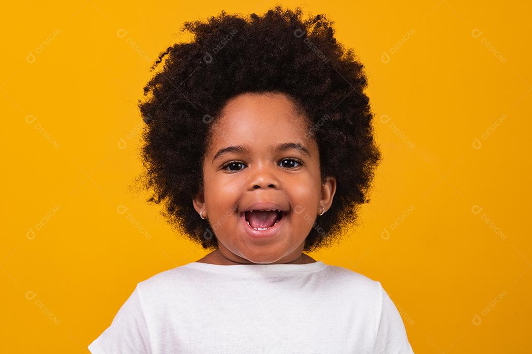 Happy black girl smiling over isolated yellow background