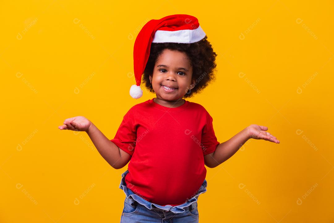 Menina afro de camiseta vermelha e chapéu de Papai Noel vestido para cristo