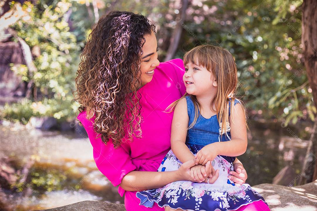 mãe com a filha no colo no parque. Linda jovem mãe com a filha no parque. Mãe solitária. Dia das Mães