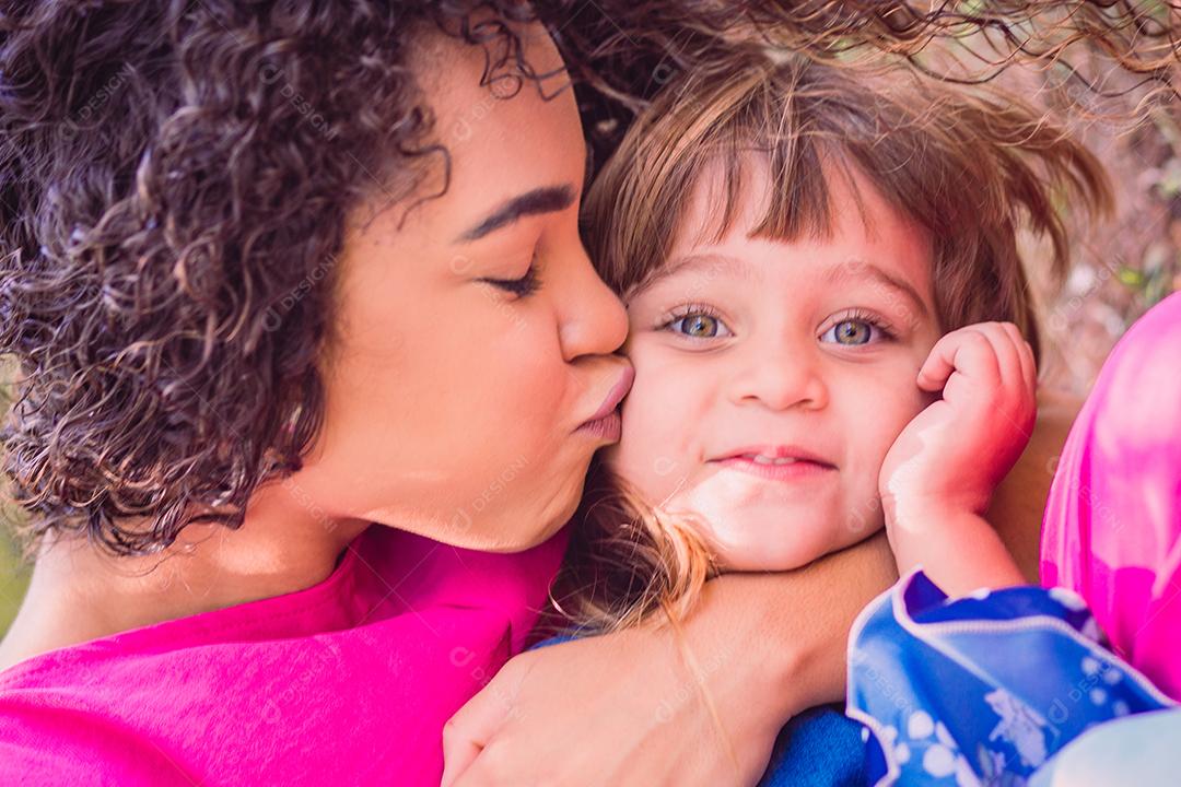 adorável jovem mãe com sua filha trocando carinho. mãe e filha no parque. feliz Dia das Mães