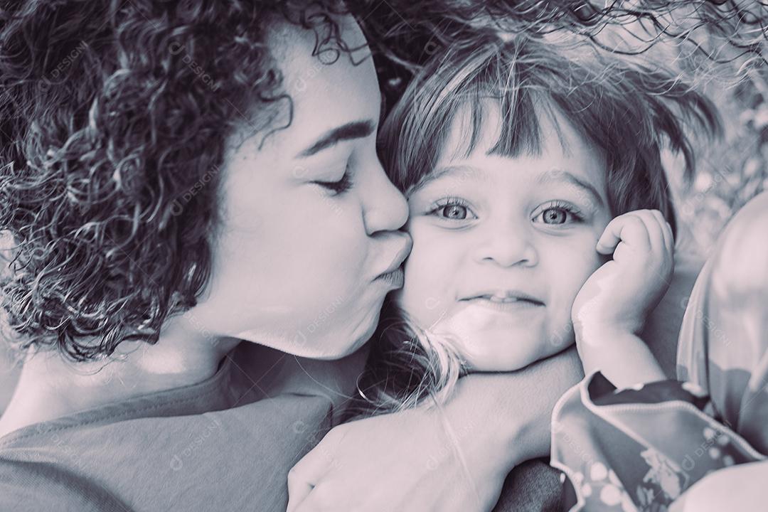 adorável jovem mãe com sua filha trocando carinho. mãe e filha no parque. feliz Dia das Mães