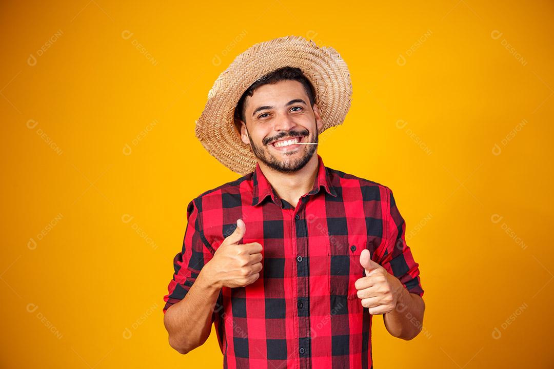 homem vestido com roupa de festa junina com polegar para cima