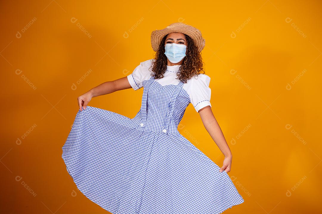 Mulher com roupas típicas da famosa festa brasileira chamada Festa Junina em comemoração ao São João