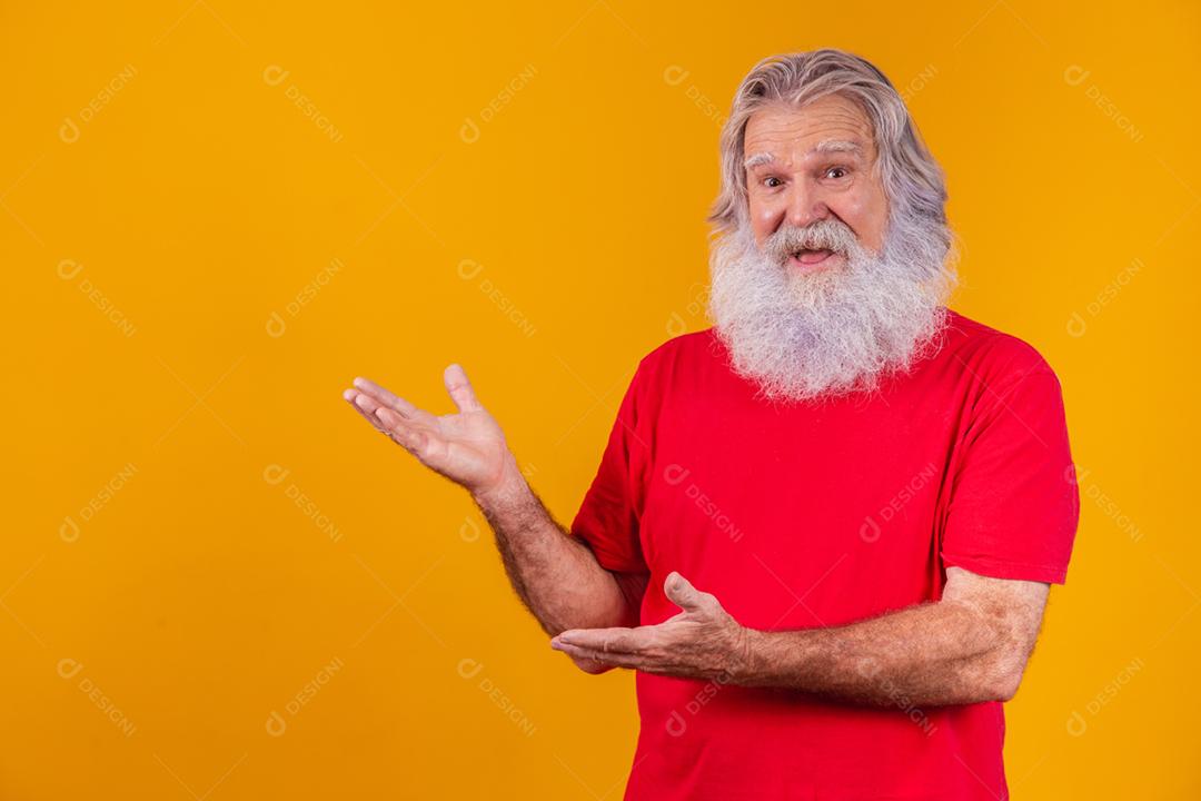 Old man with a long beard pointing to the side on a yellow background