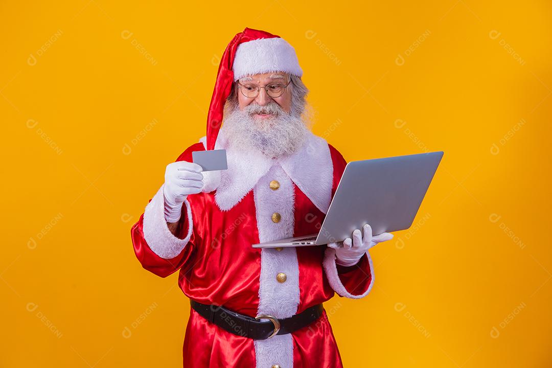 Santa Claus Showing a Card and Calling on Laptop