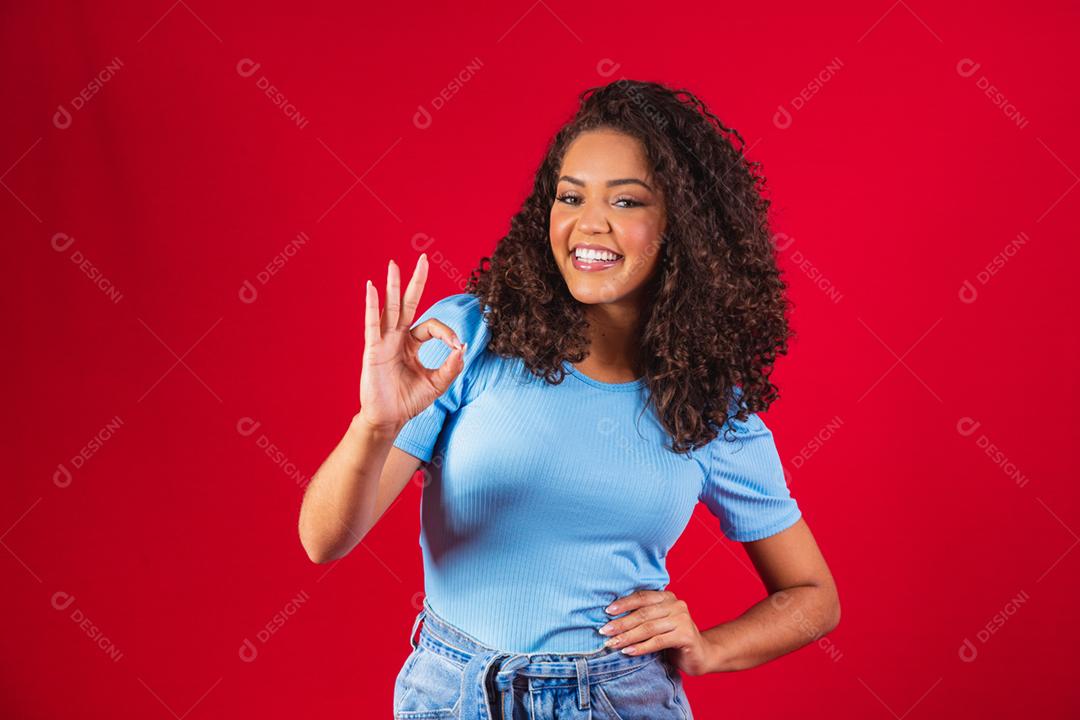 Smiling afro young man making ok sign.