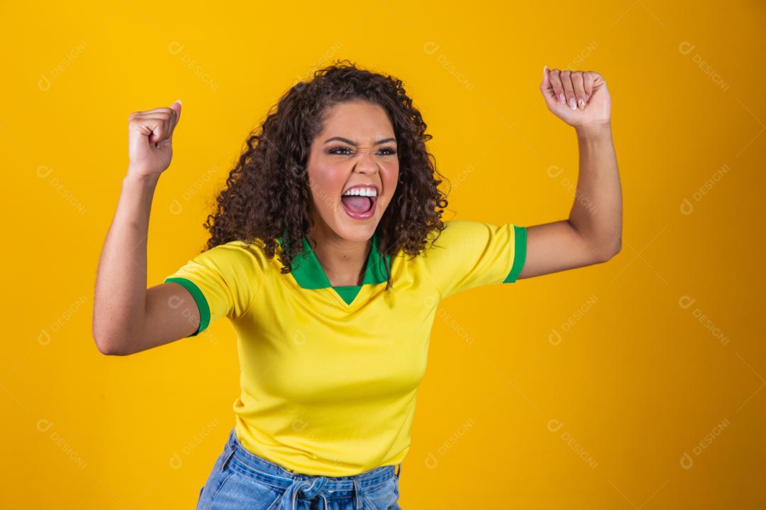 Torcedora do Brasil, mulher brasileira de cabelo encaracolado comemorando