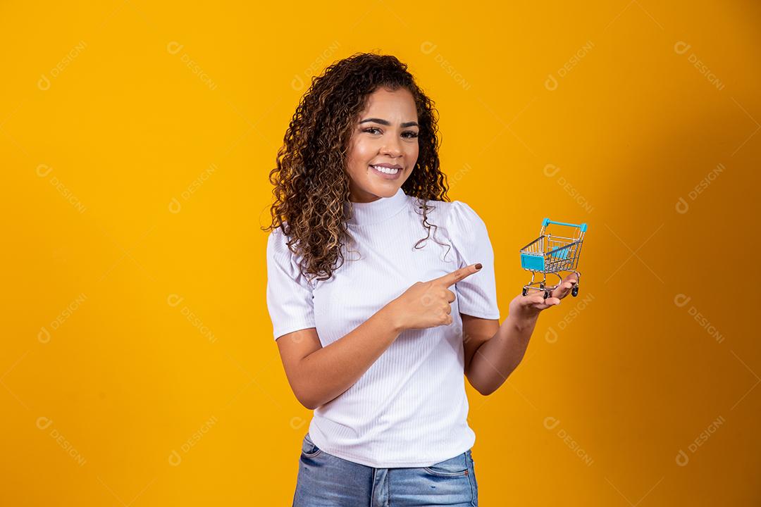 Mulher com pequeno carrinho de compras Sorrindo