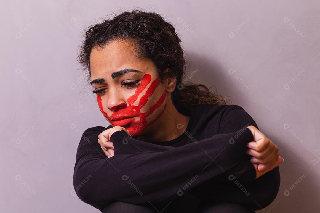 Female with a print in her mouth, demonstrating violence against women. Woman protesting against violence