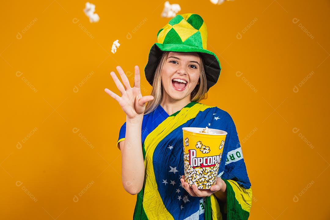 Brazilian fan with popcorn to watch the game