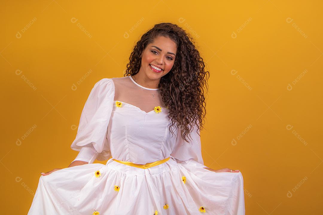jovem afro vestida para festa junina sorrindo para a câmera