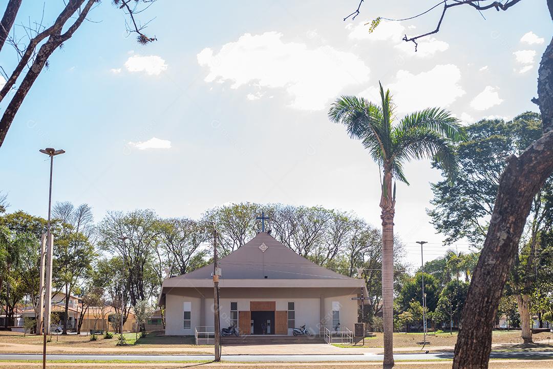Drought landscape with white church and trees with green leaves