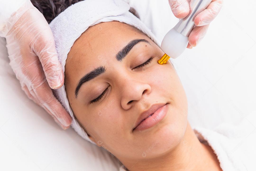 mulher aplicando jato de plasma no rosto